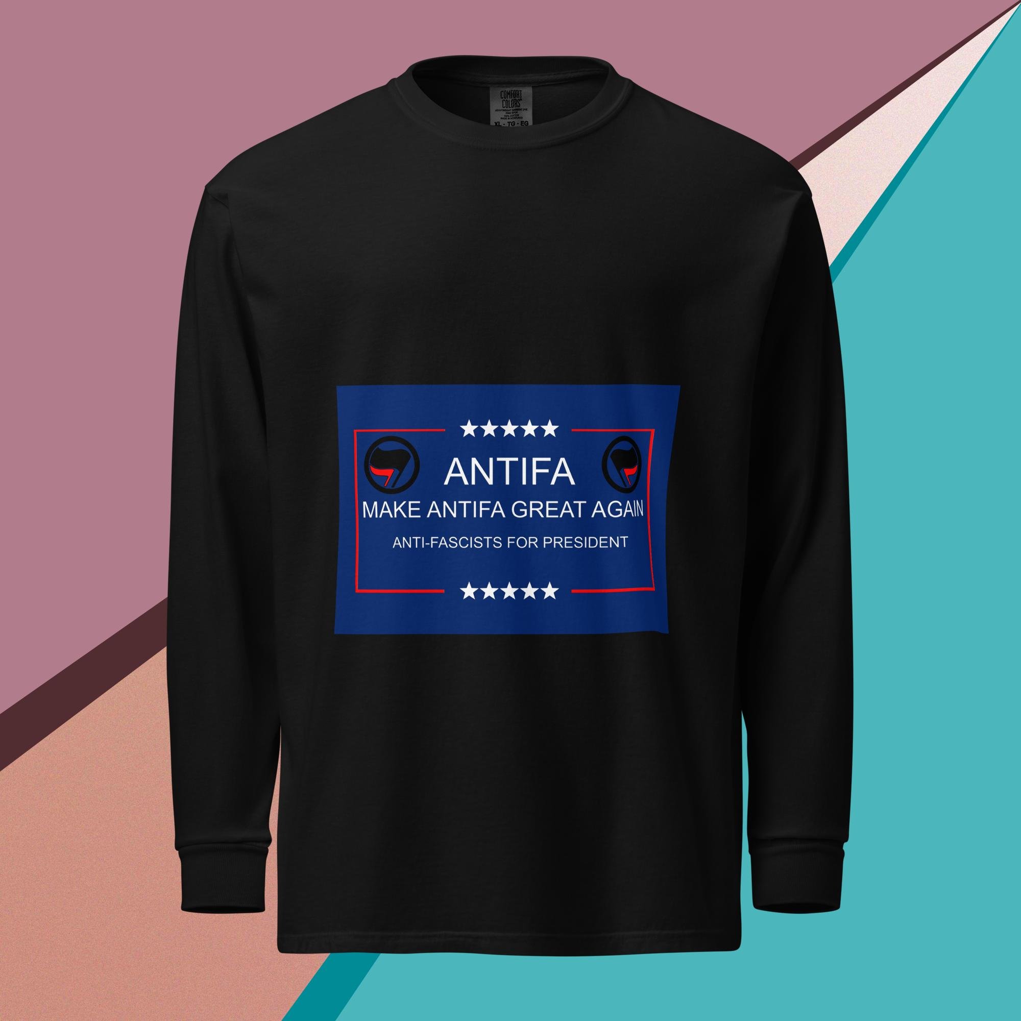 The design says: Antifa Make Antifa Great Again Anti-Fascists for President The design is a play on words with MAGA. There are also 5 stars on both the top and bottom, and the Antifa flag on the upper left and right of the design unisex garment dyed heavyweight long sleeve shirt black