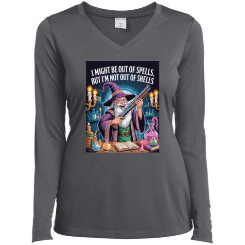 A woman models an iron grey long-sleeved V-neck tee featuring a wizard holding a shotgun amidst potions and spellbooks. The shirt reads: "I might be out of spells, but I'm not out of shells." A fun D&D gamer shirt.