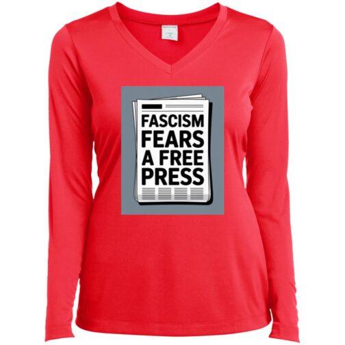 Hot coral women's V-neck long sleeve tee with a graphic of a newspaper that reads "Fascism Fears A Free Press," promoting activist apparel.