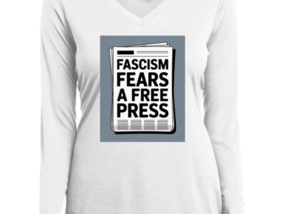 White women's v-neck long sleeve performance tee featuring a newspaper graphic that reads "Fascism Fears A Free Press." Activist apparel promoting First Amendment rights.