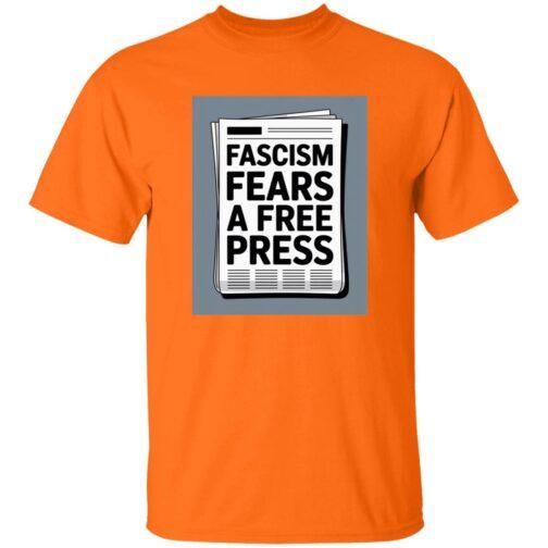An orange t-shirt featuring a graphic of a newspaper with the bold text "Fascism Fears A Free Press," highlighting the importance of a free press. Activist apparel.