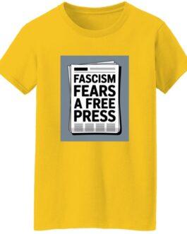 A yellow "Fascism Fears A Free Press" t-shirt with a newspaper graphic on the front. The bold black text on the newspaper reads "Fascism Fears A Free Press.