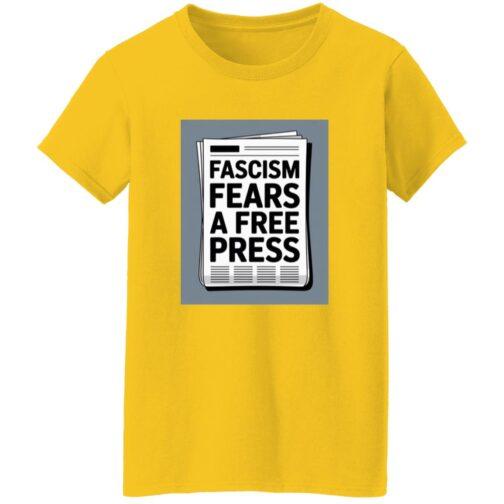A yellow "Fascism Fears A Free Press" t-shirt with a newspaper graphic on the front. The bold black text on the newspaper reads "Fascism Fears A Free Press.