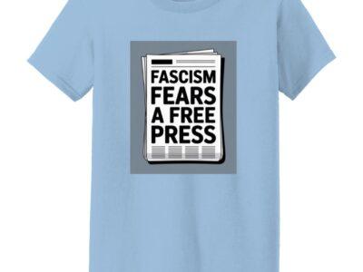 Light blue “Fascism Fears A Free Press” women's classic fit cotton tee featuring a newspaper graphic. Activist apparel supporting journalism and the First Amendment.