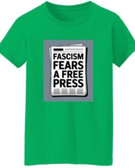 A green women's classic fit cotton tee, size small, with a graphic of a newspaper headline that reads "Fascism Fears A Free Press." This activist t-shirt promotes freedom of the press.