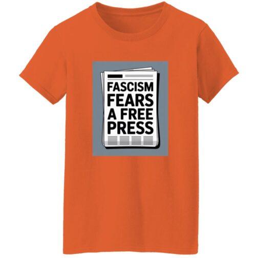 An orange women's classic fit cotton tee with a graphic of a newspaper headline that reads, "Fascism Fears A Free Press." This activist t-shirt promotes freedom of the press.