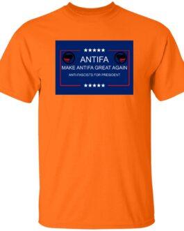 Safety orange t-shirt featuring a blue rectangle graphic with "ANTIFFA" in white text, "MAKE ANTIFFA GREAT AGAIN" and "ANTI-FASCISTS FOR PRESIDENT" below, flanked by Antifa flag symbols. A protest tee.