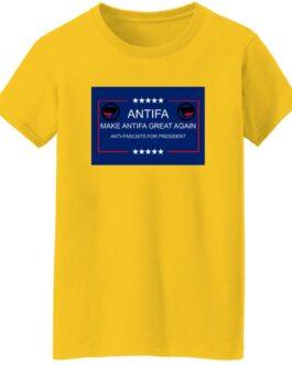 A yellow "Make Antifa Great Again" t-shirt with a blue and red design featuring "Antifa" text and crossed flags. The design promotes an anti-fascist message for president.