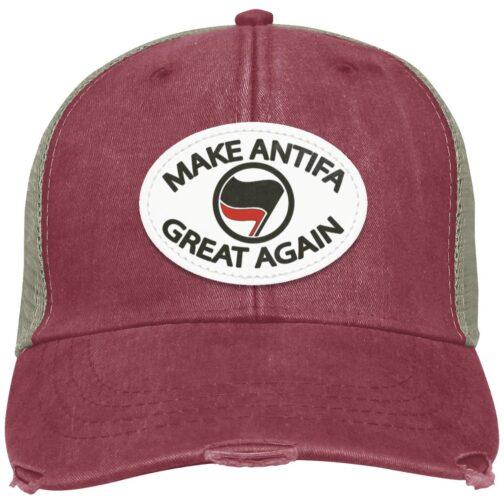 Distressed nautical red "Make Antifa Great Again" hat. This Adams trucker cap features a vegan leather patch with the Antifa flag on an oval. The cap has a worn, vintage look.