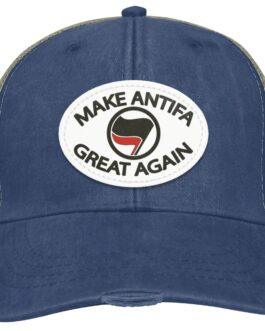 A navy blue "Make Antifa Great Again" hat. This distressed Adams trucker cap features a vegan leather oval patch with the Antifa flag. A stylish piece of anti-fascist apparel.