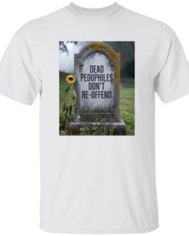 A white t-shirt displays an image of a tombstone with the text "Dead Pedophiles Don't Re-Offend" etched on it. A single sunflower leans against the stone in a somber graveyard setting. This political tee makes a statement.