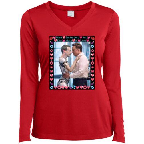 A red Sport-Tek ladies' V-neck shirt features a humorous graphic of Elon Musk embracing a robotic Mark Zuckerberg, framed by hearts and lips. The text reads: "Mark Zuckerberg And Elon Musk In Love." A satirical take on AI and tech personalities.
