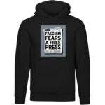 Black unisex premium hoodie featuring a graphic print of a newspaper with the bold text "FASCISM FEARS A FREE PRESS" in white.