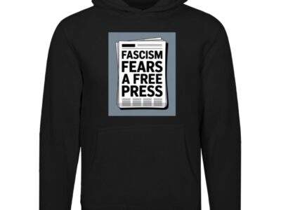 Black unisex premium hoodie featuring a graphic print of a newspaper with the bold text "FASCISM FEARS A FREE PRESS" in white.